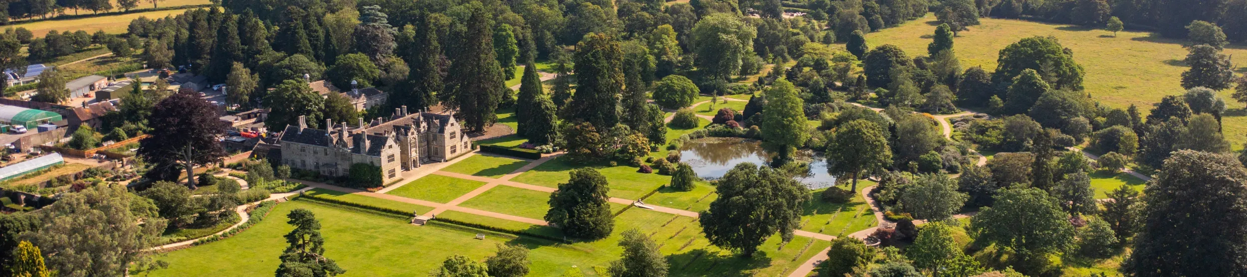 Aeriel view of Wakehurst showing the Mansion and the view across the High Weald
