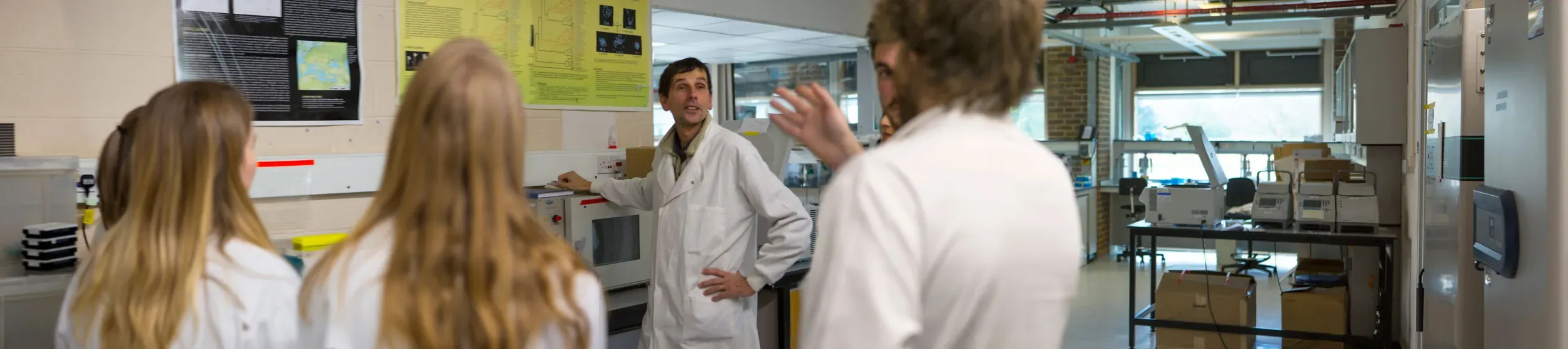 Group of students in a lab on a tour Group of students in a lab on a tour