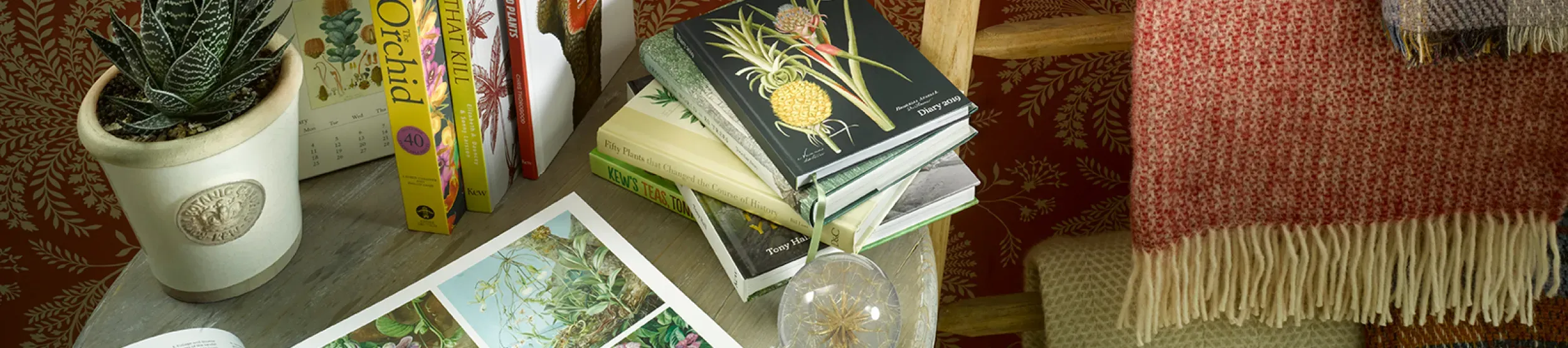 Kew products available to buy ©RBG Kew Books pulled on a coffee table along with a collection of Kew products