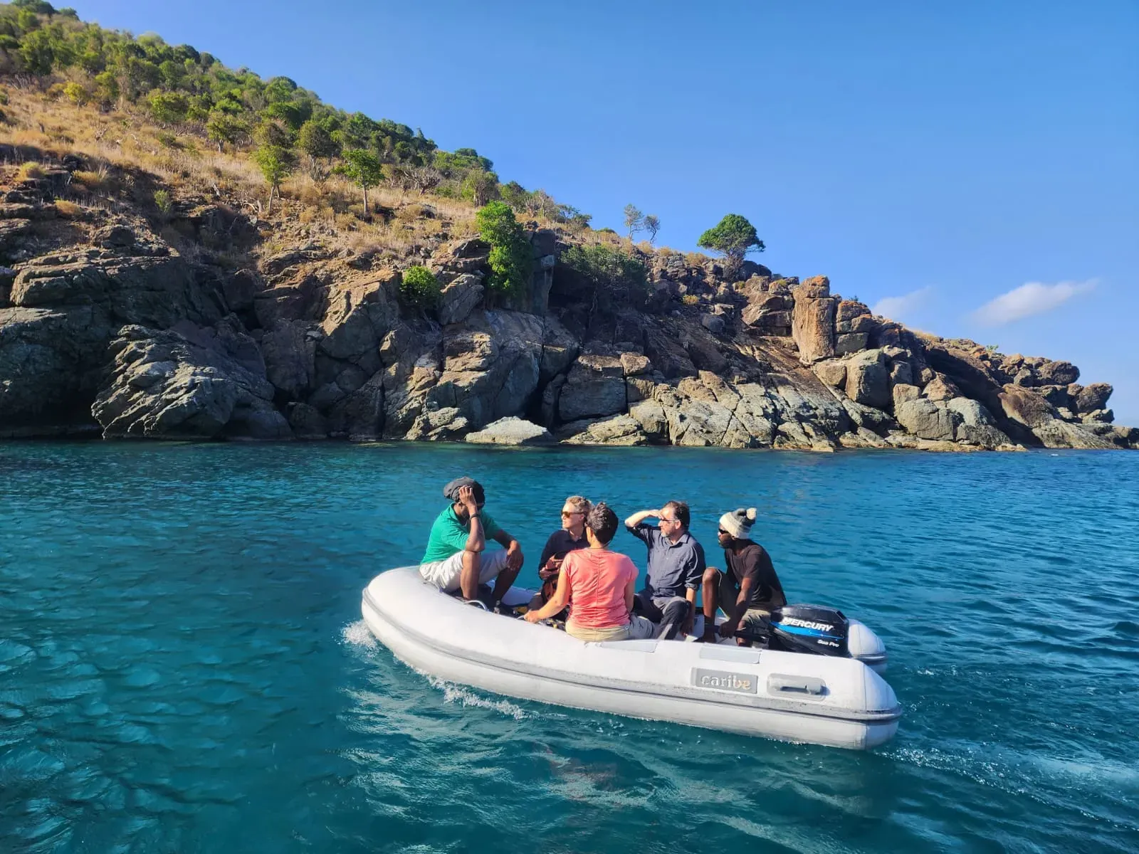 The Kew and NPTVI team approach great Tobago via dinghy. Without accessible beaches, even landing on the island is an obstacle the team must overcome © RBG Kew A team in a dinghy approach an island