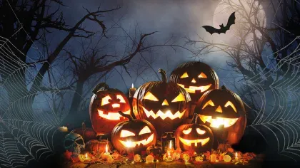Halloween at Kew © RBG Kew A pile of glowing jack-o-lanterns against a dark misty background with cobwebs and bats