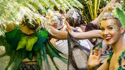 The Dream Fairies - Adventure to Bubble Land © Australian Shakespeare Company A smiling fairy surrounded by other fairies in the green undergrowth