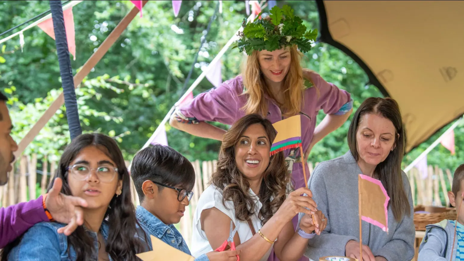 Oaklore at Kew Gardens, Ines Stuart-Davidson © RBG Kew A person in a purple jump suit overseeing a crafting activity for families