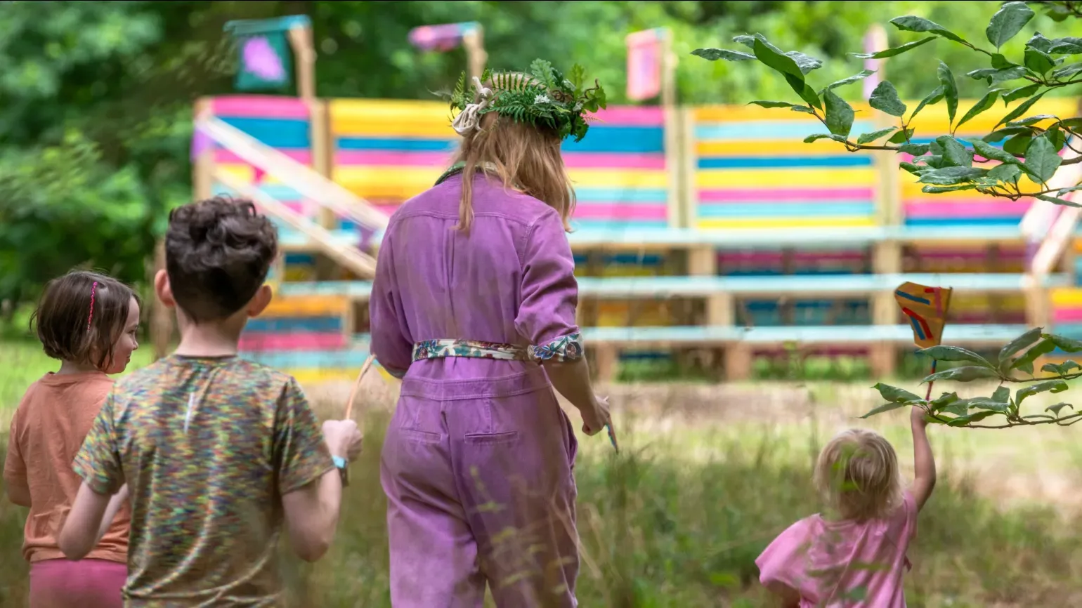 Oaklore at Kew Gardens, Ines Stuart-Davidson © RBG Kew People walking through a forest towards a colourful amphitheatre