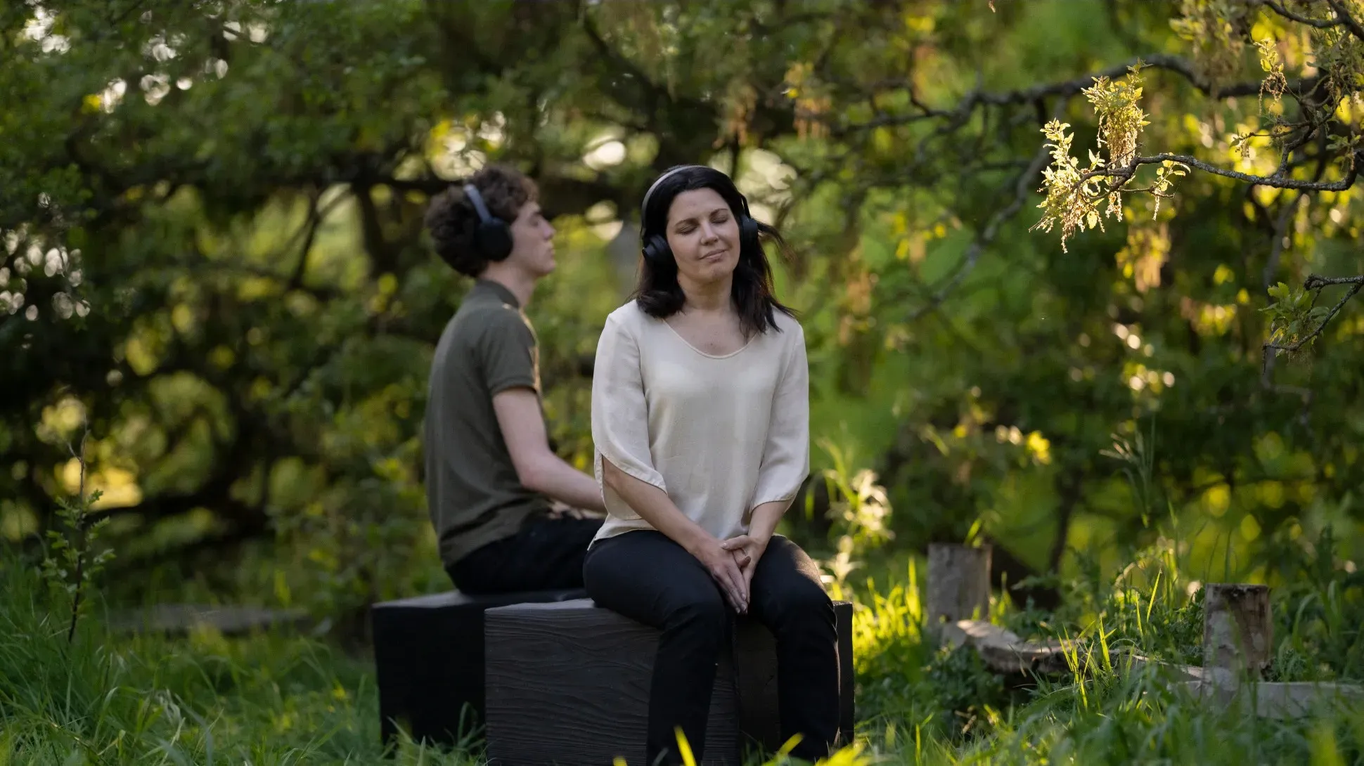 Of the Oak Meditation, © Barney Steele Two people sitting with headphones and meditating in a forest