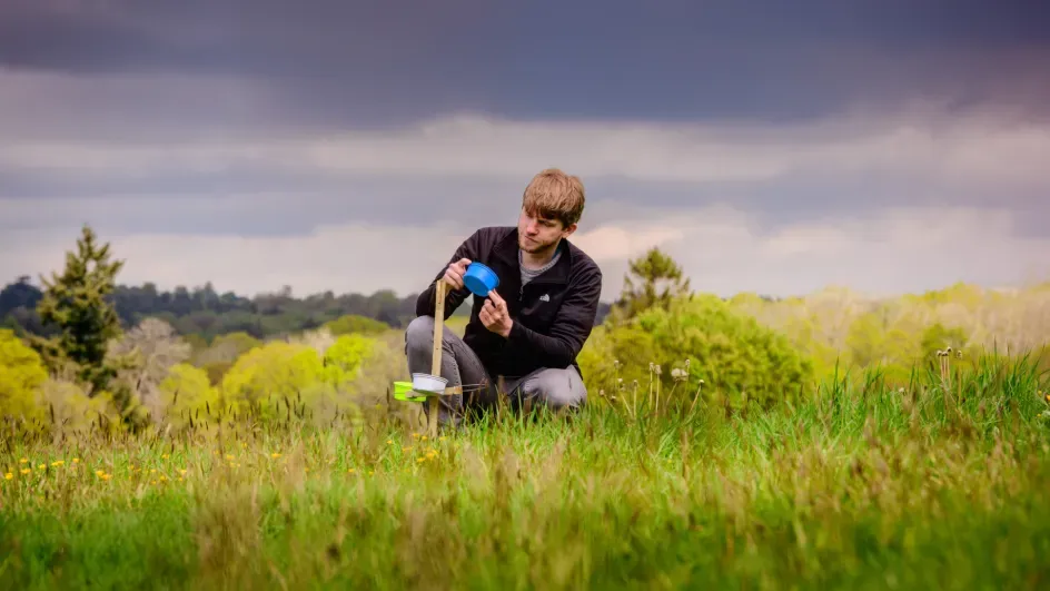 A Nature Unlocked researcher examines a monitoring station, Jim Holden © RBG Kew