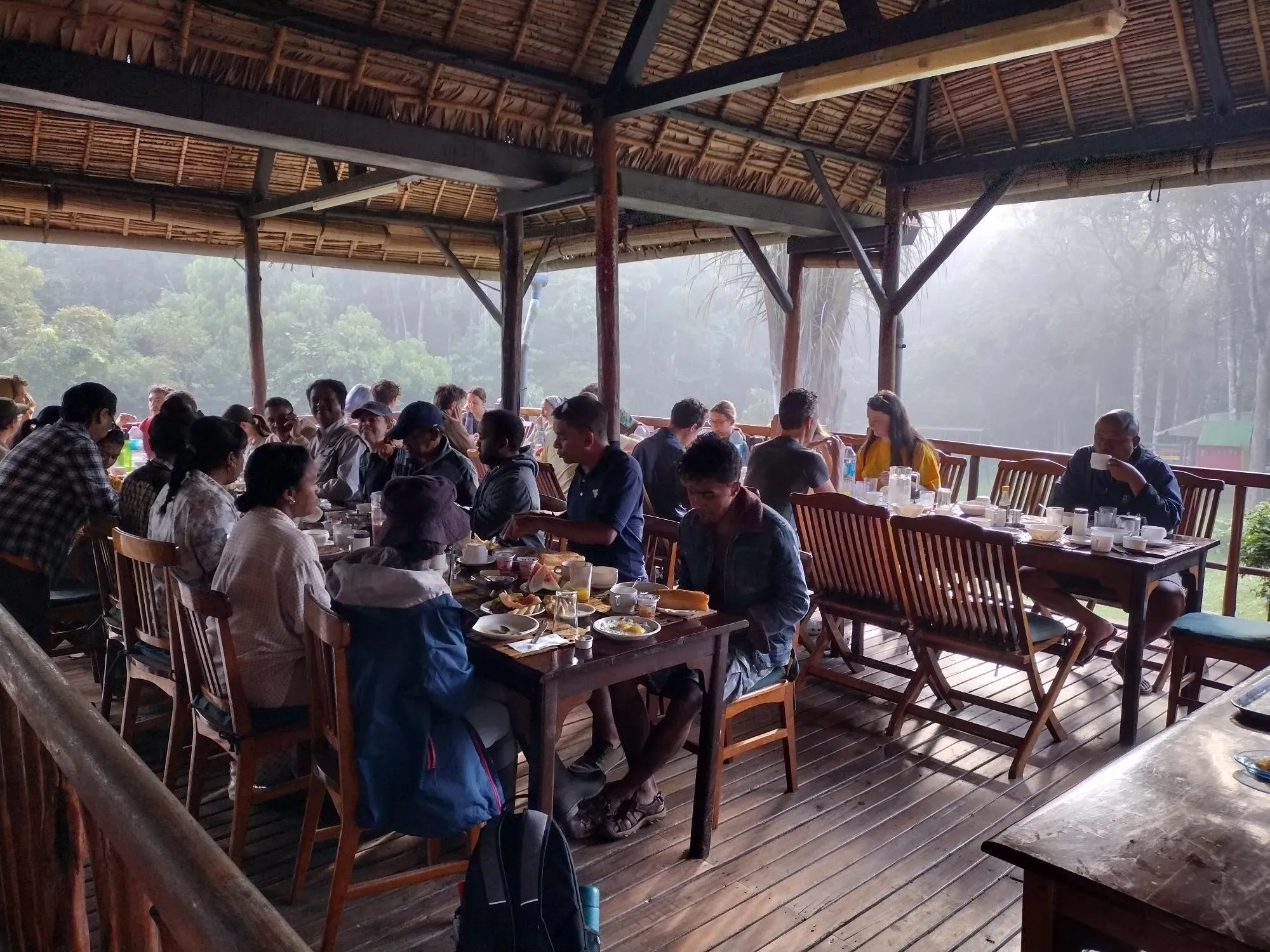 Dinners at Feon'ny Ala Hotel. Fiona Wilkie © RBG Kew Around 30 people sitting at tables eating